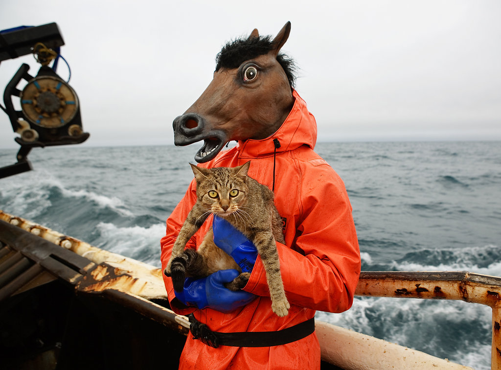 A crew member on the f/v Rollo tries out his Halloween costume and holds the boat Kitty.